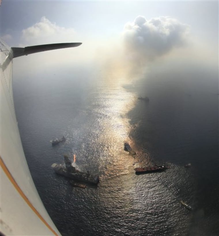 Activity at the site of the Deepwater Horizon oil spill in the Gulf of Mexico off the Louisiana coast is viewed from a Coast Guard plane Wednesday, June 9, 2010. (AP Photo/Charlie Riedel)